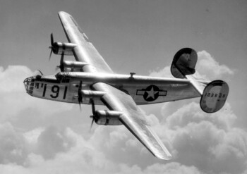 A Consolidated B-24 Liberator from Maxwell Field, Alabama, four engine pilot school, glistens in the sun as it makes a turn at high altitude in the clouds. Heavy Bombers